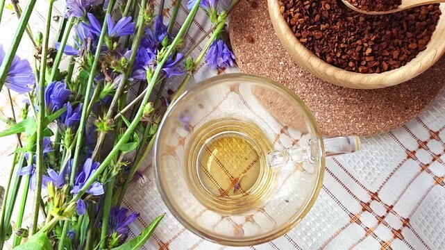 Ground chicory root, chicory flowers and chicory drink on a rustic wooden background. Alternative medicine. Healthy drinks