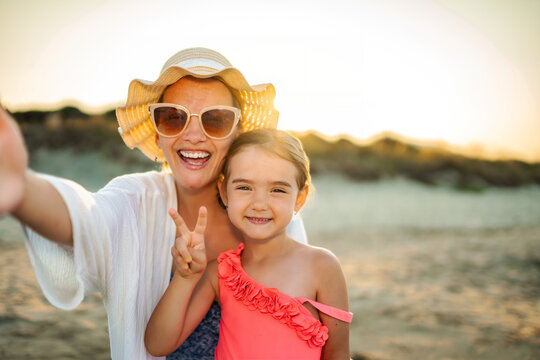Mother daughter taking selfie on family summer vacation