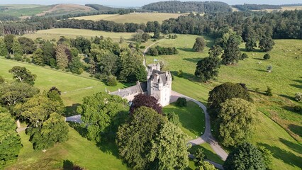 Panoramic drone stock photo of Castle Fraser Garden and Estate showcasing medieval turrets and manicured green grounds in Aberdeenshire, Scotland, United Kingdom © Ramses