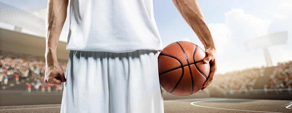 Basketball. Close-up of professional basketball players against the backdrop of the court. Sports close-up. Confidence in victory.