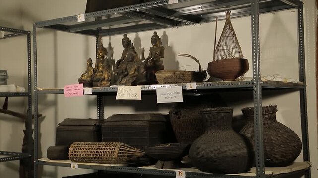 Display of traditional ancient bamboo crafts and antique copper sculptures preserved in Majuli Assam India 4K footage