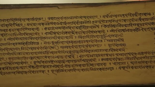 Close up shot of ancient historical manuscript written on traditional Sanchipat bark preserved in Guwahati Assam India 4K footage
