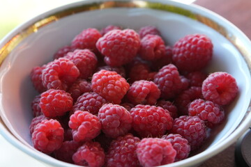 Juicy Red Raspberries in a White Bowl Healthy Summer Dessert Snack © Jekaterina