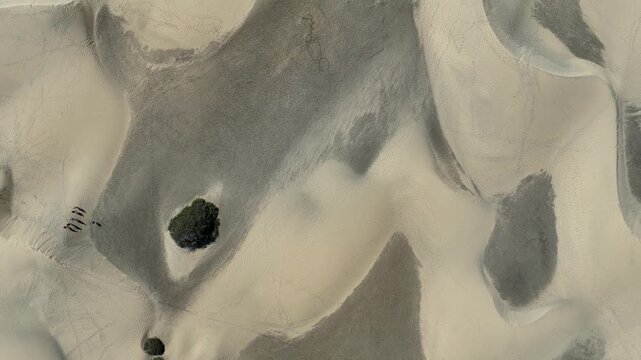 Top down flight over Maspalomas Dunes with footprints in Playa del Ingles on Canary Island Gran Canaria, Spain