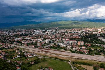 Fototapeta premium Aerial panoramic view of Niksic town and surrounding mountain landscape, Montenegro