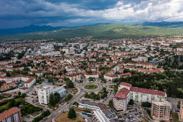 Fototapeta premium Aerial panoramic view of Niksic town and surrounding mountain landscape, Montenegro