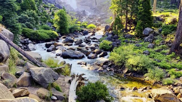 Golden sunrise light illuminates Nevada Fall and the Merced River along Yosemite's Mist Trail
