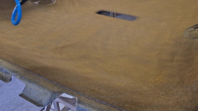 Car headliner spray, man's hand applies adhesive for auto interior restoration