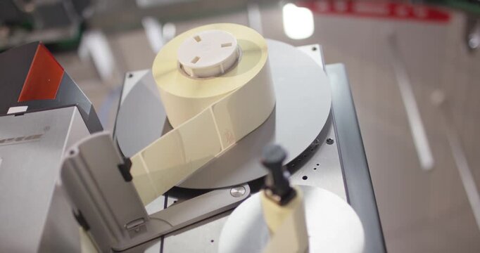 Label roll runs through an industrial printer