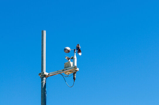 Anemometer wind gauge sensor on weather station with blue sky
