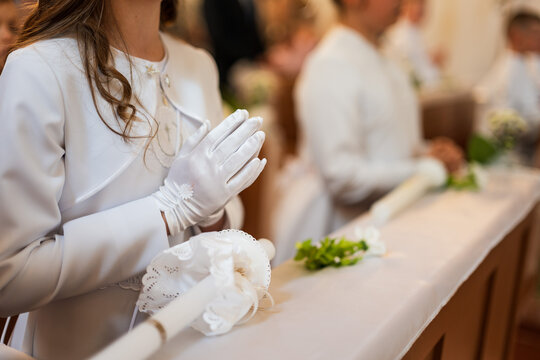 Child praying during First Holy Communion ceremony in church, capturing faith, devotion and spiritual atmosphere of a Christian celebration