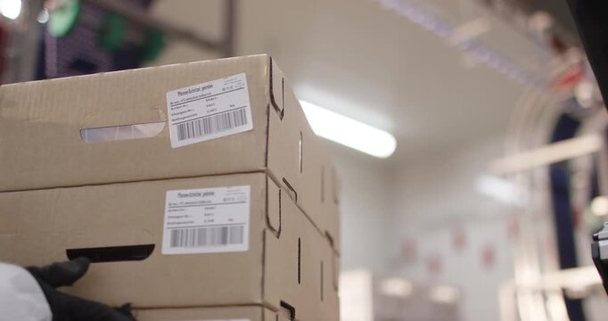 Stacked cardboard boxes with barcode labels in cold storage