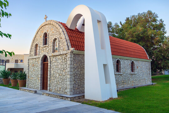 Traditional Greek Orthodox stone chapel with red tiled roof and bell arch in Kolymbia Rhodes, greece