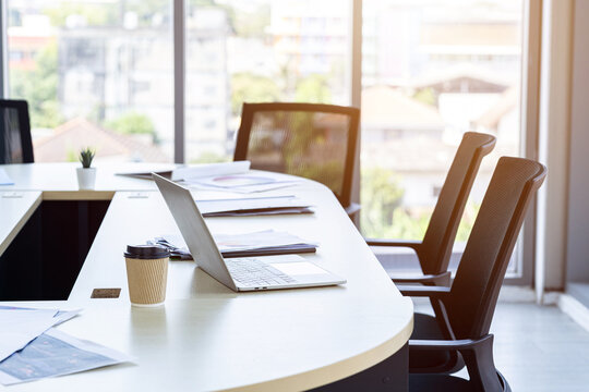 laptop, smartphone, and work files are placed office supplies on the desk background in meeting room office workspace