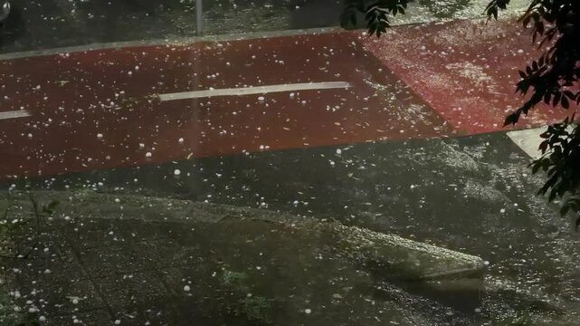 Video capturing rare giant hailstones after a powerful storm in Milan, Italy, illustrating severe weather, climate variability, and natural hazard concepts for editorial or commercial use.