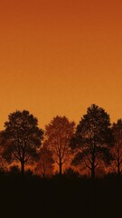 Naklejka premium Silhouetted trees against sunset mobile wallpaper