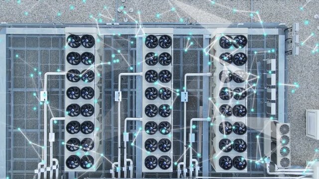 Aerial view of industrial hvac cooling towers on a rooftop with digital network connectivity overlay, representing smart building management and energy efficiency