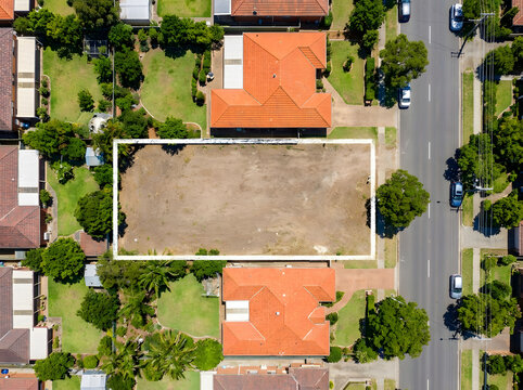 Aerial top down view of empty land parcel outlined for property sale