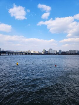 city, skyline, bridge, river, han river, seoul, urban, building, architecture, landscape, water, clouds, blue sky, outdoor, scenery, view, travel, korea, daytime, cityscape