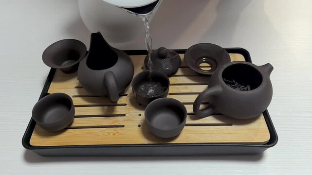 Enjoy tranquility in a traditional tea ceremony with elegant teapot prep
