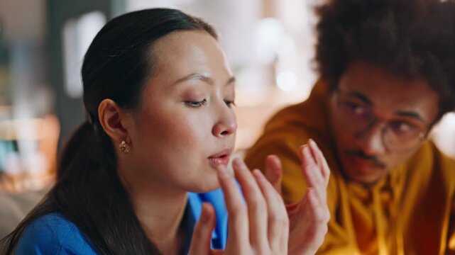 Closeup worried asian woman talking boyfriend. Multiethnic couple discussing