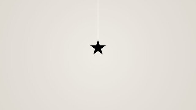 Minimalist black star hanging from a thin line on a neutral background.