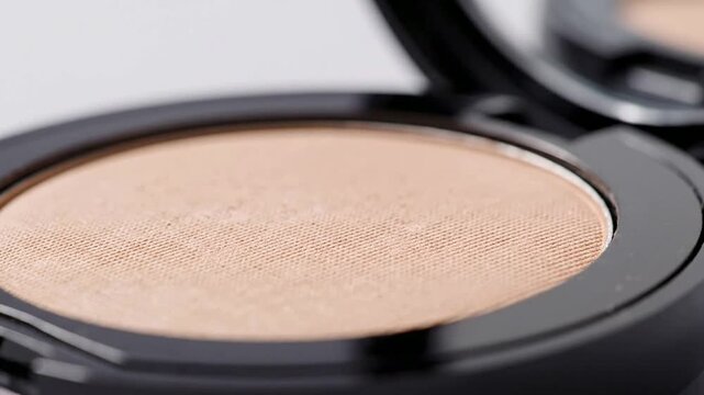 Close-Up View Of A Round Pressed Powder Compact With Soft Beige Shade Isolated On Light Background For Beauty And Makeup Product Photography