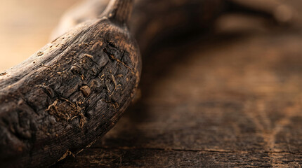 Fototapeta premium Aged dried banana peel on rustic wooden surface, close-up detail