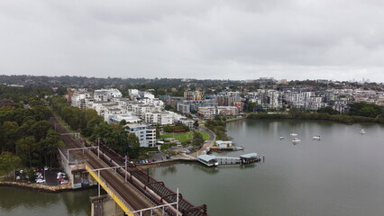 Obraz premium Aerial view of coastal suburb and railway bridge