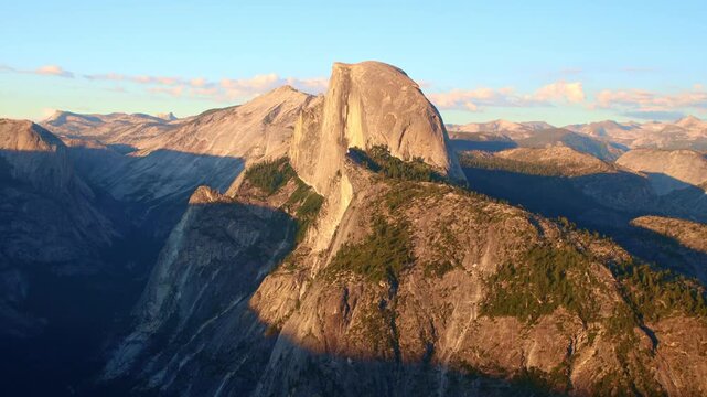 Golden sunset light bathes Half Dome as seen from Glacier Point in Yosemite
