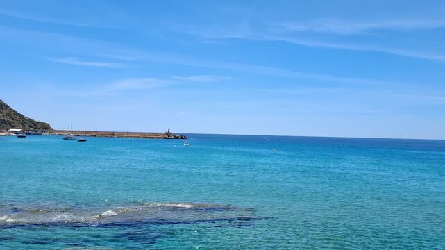 Panoramic view of Mediterranean sea resort in Calp, transparent clear blue water on a sunny summer day, travel and vacation concept, 4K.