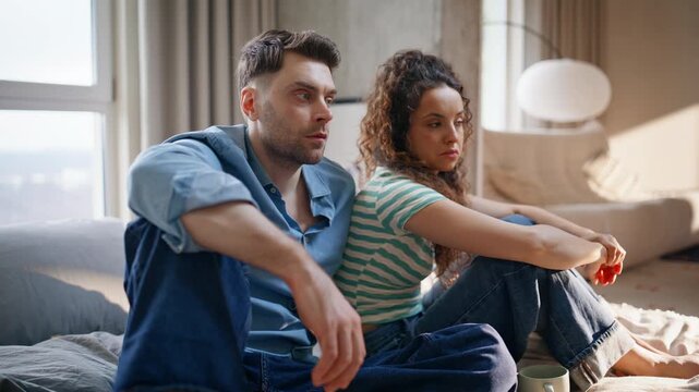 Man woman sitting back to back after quarrel. Couple ignoring each other home.