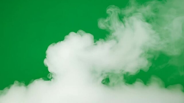 A thick plume of white smoke rises against a solid green background