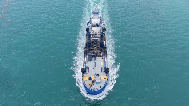 Industrial petrochemical tanker. Fuel tanker vessel. Bunkering tanker aerial top view. Industrial vessel cruising through the sea. Aerial view bunkering vessel. Supplying fuel bunker