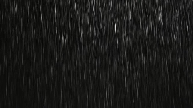 A heavy downpour of rain falling against a dark background
