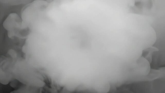 A top view of white textured objects arranged in a circular spiral pattern with swirling smoke