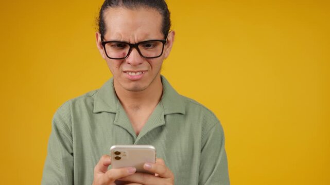 Disgusted young man reacting to bad news on smartphone