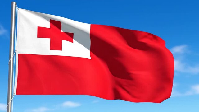 The national flag of Tonga waving against a clear blue sky