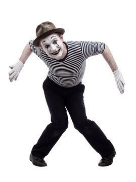 Smiling Mime Artist Performing Dynamic Pose in Traditional Striped Costume Isolated