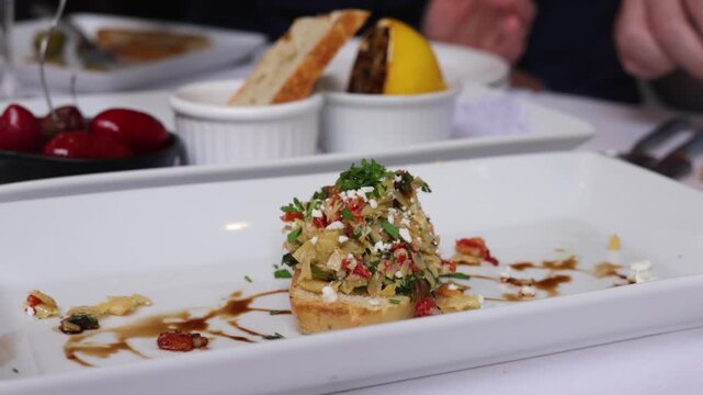 Gourmet bruschetta appetizer close-up on white restaurant plate