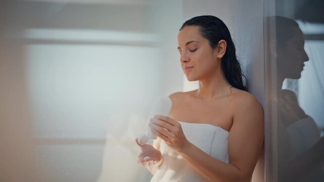 Woman applying body lotion after shower. Close up beauty skincare moisturizing