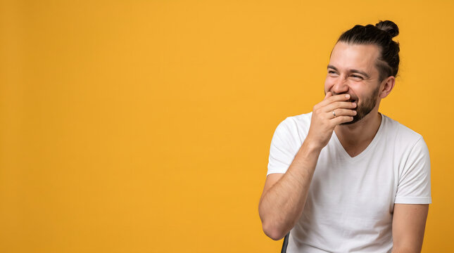 Man Laughing Covering Mouth with Hand.