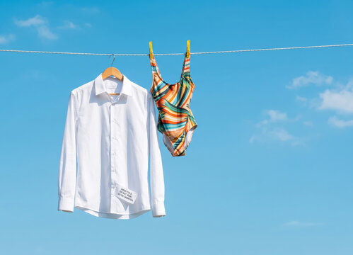 White Business Shirt and Swimsuit on Clothesline Representing Vacation Priority and Paid Leave
