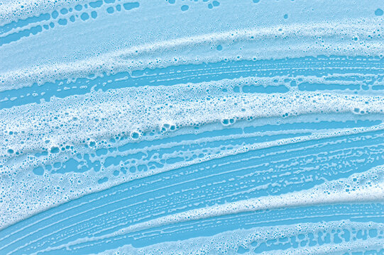 Close-up of foam pooling on a blue backdrop