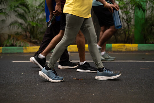 Group of People Walking for Fitness on Wet Park Road in Chennai, India