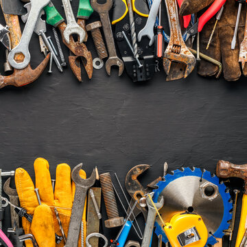 Group of worn work tools. Collection of used blue collar work equipment covered with old board. For home improvement, diy repair projects, Father's day gift ideas, or to celebrate Labor Day.