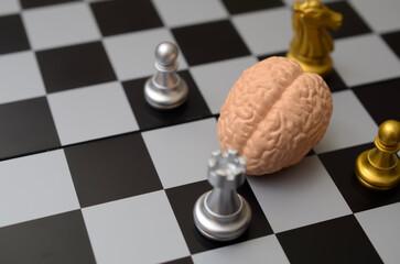 Business intelligence and competition strategy showing brain model among chess pieces. © TeacherPhoto