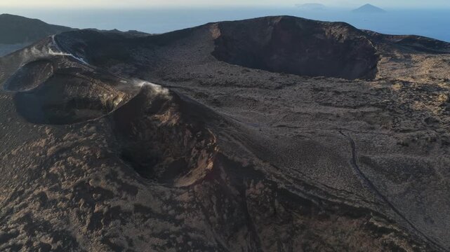 Aerial view of four volcanic craters with steaming vents on Mount Mihara Izu Oshima Japan