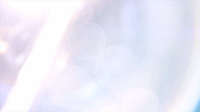 Abstract soft light leaks and cinematic lens flare transition effects.