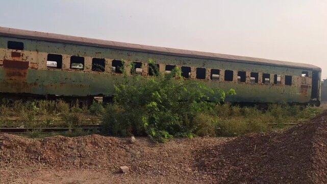 Abandoned and Rusty Passenger Train Carriage Left Decaying on Roadside Track
